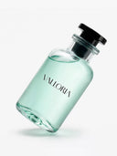 VALLORIA Kaptaan luxury perfume in a minimalist clear glass bottle featuring fresh mint green liquid and a premium black cap, tilted on a white background.